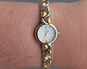 Vintage BULOVA Two Tone Quartz Watch with Pearlescent Face, Heart Link Band and New Battery. Best fits up to 6.5” wrist.