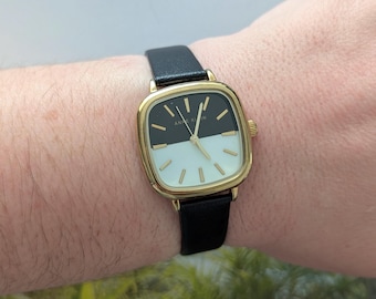Vintage ANNE KLEIN Gold Tone Quartz Watch with Black and White Face, New Black Leather Band and New Battery.  Best fits 7” wrist or smaller.