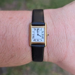 Vintage SEIKO Gold Tone Tank Quartz Watch with New Black Leather Band, Roman Numeral Detail and New Battery.  Best fits 7” wrist or smaller.