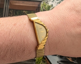 Vintage SEIKO Half Moon Watch from Gold Tone Quartz Watch with new battery. Fits 6.5” wrist or smaller.