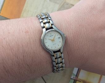 Vintage SEIKO Two Tone Quartz Watch with Round Bezel, Date Detail and New Battery. Best fits 7” wrist or smaller.