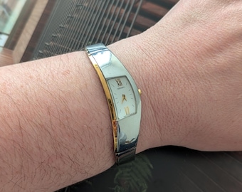 Vintage SEIKO Two Tone Asymmetrical Quartz Watch with White Face and New Battery. Best fits 6” wrist or smaller.