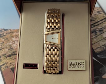 Vintage SEIKO Gold Tone Asymmetrical Quartz Watch with Oringla Box and  new battery. Fits best on 6.5” wrist or smaller.