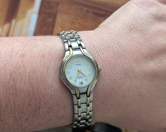 Vintage TIMEX Two Tone Quartz Watch with White Face, Date Detail and New Battery. Best fits up to 7” wrist or smaller.