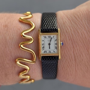 Vintage SEIKO Gold Tone Tank Quartz Watch with New Black Leather Band, Blue Crown and New Battery.  Best fits 7” wrist or smaller.