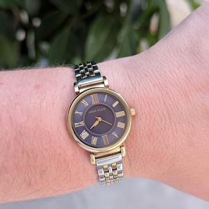 Vintage ANNE KLEIN TEO Tone Quartz Watch With Blue Face, Round Bezel and New Battery. Best Fits 7” wrist or smaller.