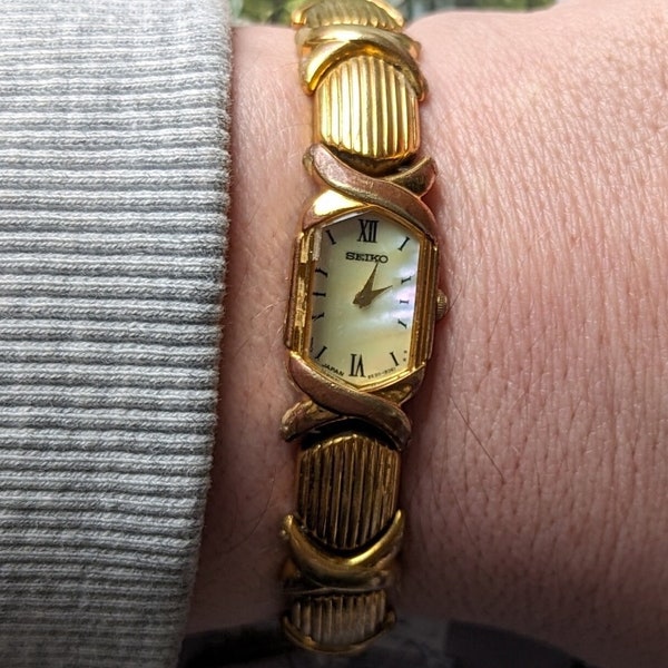 Vintage SEIKO Gold Tone Quartz Watch with  Pealescsent face and New Battery. Best fits 6.5 wrist or smaller.