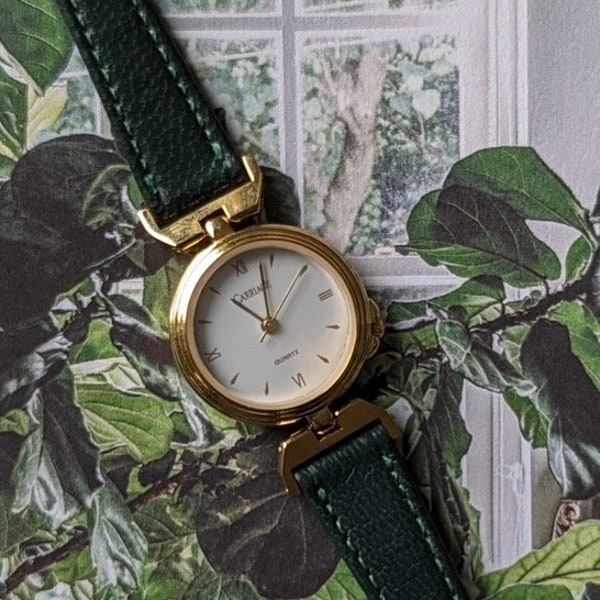 Vintage Carriage by TIMEX Gold Tone Quartz Watch with Green Leather Band and New battery. Best fits up to 7” wrist.