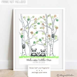 May include: A framed print featuring a panda family under birch trees with green and brown leaves. The text "Welcome Little One, You Are So Loved" is displayed. A card below invites guests to leave fingerprints and sign their names.