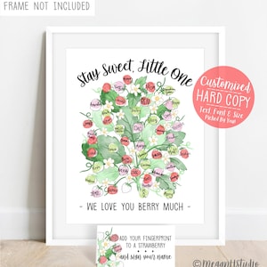 May include: A white framed print featuring a watercolor strawberry plant illustration with names written on each berry. Text reads: Stay Sweet, Little One and WE LOVE YOU BERRY MUCH. A small instruction card is included at the bottom.
