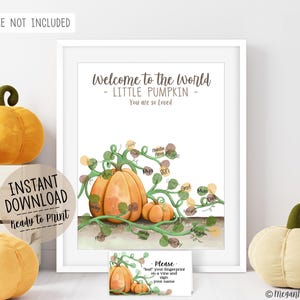 May include: A white-framed print featuring a pumpkin illustration with green vines and space for fingerprints. Text reads: Welcome to the World - LITTLE PUMPKIN - You are so Loved. Includes a small instruction card for guests to sign and add fingerprints.