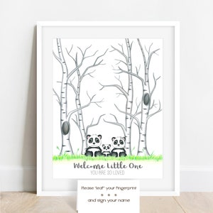 May include: A framed print featuring a watercolor illustration of a panda family in a forest setting. The artwork includes birch trees, green grass, and the text "Welcome Little One, You Are So Loved." A small card below invites guests to leave fingerprints.