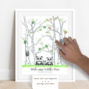 May include: A framed print featuring a whimsical illustration of birch trees with green leaf accents. Below the trees are three panda bears. The text "Welcome Little One, You Are So Loved" is displayed. A card below reads "Please 'leaf' your fingerprint and sign your name."
