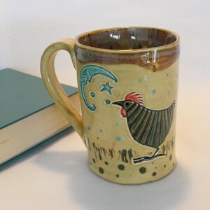 May include: A white ceramic mug with a black handle and the text "But First, Coffee" in a black, bold font. The mug is likely 4 inches tall and holds approximately 12 ounces of liquid.