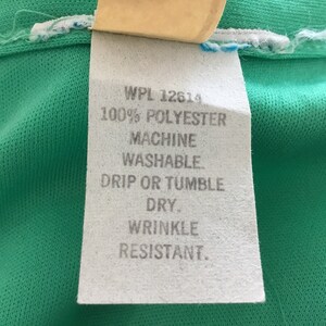 May include: White care label with the text "WPL 12614 100% POLYESTER MACHINE WASHABLE. DRIP OR TUMBLE DRY. WRINKLE RESISTANT."