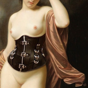 May include: A black leather corset with silver buckles and a zipper closure. The corset is worn by a person with a bare chest and a pink silk shawl.