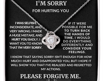 May include: A silver necklace with a crystal knot pendant comes in a black box with a message that reads "I'm sorry for hurting you. I was selfish, inconsiderate, and very wrong. I made a huge mistake, and hurt you badly. I want you to know that I'm very sorry. If it were possible for me to turn back the hands of time, I would do everything differently and consider your feelings. I know that saying sorry isn't enough for how much I hurt and disappointed you, but I hope it will show you that I've realized and regretted my actions. Please forgive me."