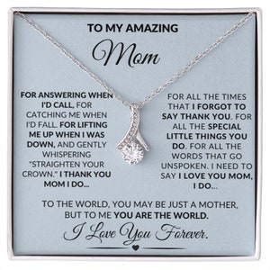 May include: A silver necklace with a clear crystal pendant in a gift box. The box has a message for a mom that reads "To my amazing Mom. For answering when I'd call, for catching me when I'd fall. For lifting me up when I was down, and gently whispering "straighten your crown." I thank you Mom I do... For all the times that I forgot to say thank you. For all the special little things you do. For all the words that go unspoken. I need to say I love you Mom, I do... To the world, you may be just a mother, but to me you are the world. I love you forever."