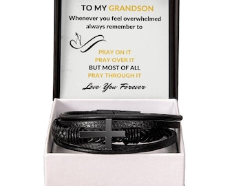 May include: A black leather bracelet with a black cross charm comes in a gift box with a message that reads "To My Grandson Whenever you feel overwhelmed always remember to Pray On It Pray Over It But Most Of All Pray Through It Love You Forever"