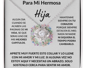 May include: A silver necklace with a knot pendant featuring a clear crystal stone. The necklace comes in a white box with a message in Spanish that reads "Para Mi Hermosa Hija" and includes a heartfelt message about love and family.