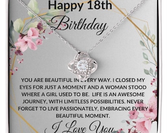 May include: A silver necklace with a knot design and a clear crystal in the center. The necklace comes in a gift box with a floral design and the text "Happy 18th Birthday" and "I Love You".