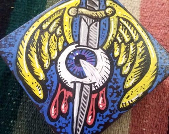 weirdo flying eyeball painted on wooden box