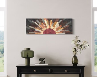 May include: A wooden wall art piece depicting a sunrise with a dark brown background and radiating beams in shades of brown, orange, and yellow. The artwork is mounted above a black console table with a green lamp and a vase.