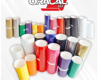 May include: A collection of rolled vinyl sheets in various colors, including gold, silver, green, purple, yellow, orange, red, pink, blue, black, and white. The brand name "ORACAL 651" is displayed at the top in red and white.