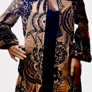 May include: A long-sleeved jacket with a black velvet zipper and a brown and black paisley pattern.