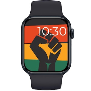 May include: A black smartwatch with a screen displaying a raised fist graphic in black, orange, green, and red. The time 10:30 is shown in white. The watch has a black band and a black side button.