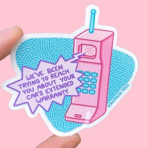 May include: A pink retro phone with a blue antenna and a blue and white patterned background. The phone has a speech bubble coming out of it that says "We've been trying to reach you about your car's extended warranty". The text "SCRAMBLED PEGS" is at the bottom of the image.