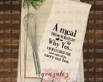 May include: White kitchen towel with black text that reads "A meal from scratch? Why Yes... I scratched the label right off the carry out box." A stainless steel whisk rests on a white wooden tray.