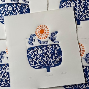 handmade linocut artwork featuring birds and a tree in retro style