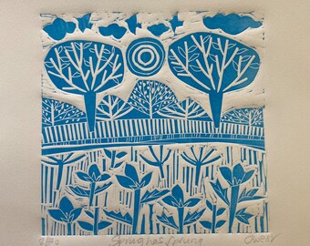 May include: Blue and white linocut print of a landscape with trees and flowers. The print is titled "Spring has sprung" and signed "Awesy".