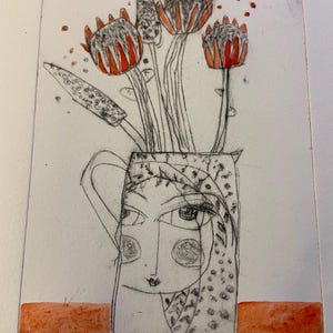 Peut inclure: Une œuvre d'art gravée représentant un vase avec un visage, contenant des fleurs stylisées aux détails rouges et noirs. Le vase est posé sur une base rectangulaire orange. Le texte "Girl Jug" est visible.