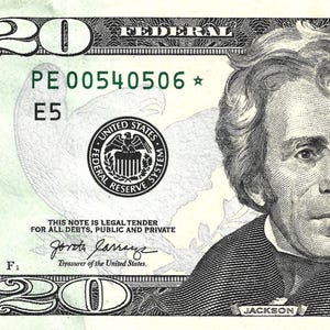 May include: A twenty-dollar bill featuring a portrait of Andrew Jackson. The bill has a green and black design with the text "Federal Reserve Note" and "Twenty Dollars". The serial number is visible.