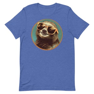 May include: A blue t-shirt featuring a circular graphic of a sloth wearing sunglasses. The sloth is brown and has a light blue background.