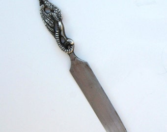 antique silver letter opener with a griffin shaped handle, marked / signed