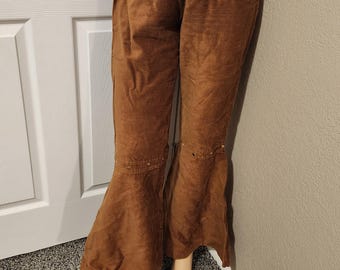 May include: Brown corduroy bell bottom pants with a wide leg and a high waist. The pants have a belt loop and a button closure.