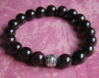 USA Tariffs paid by SELLER 10mm Garnet stretch bracelet with a Sterling Silver Bali Bead