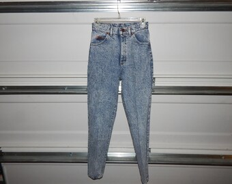 May include: A pair of light blue acid wash jeans with a high waist and a straight leg.