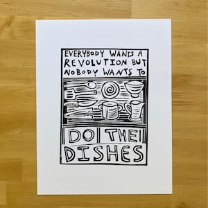 May include: Black and white illustration of kitchen utensils and dishes with the text "Everybody wants a revolution but nobody wants to do the dishes."