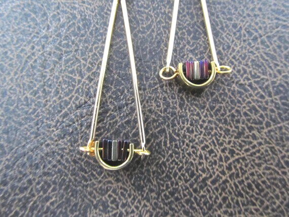 Gold pendulum earrings, purple hematite