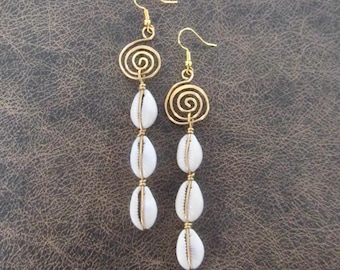 May include: Gold earrings with a spiral design and three white shell beads hanging from each earring.