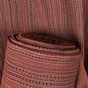 Rust copper brown textured cotton fabric, heavy weight and thick, mud cloth style black screen print in neutral earth-tone color PHA198