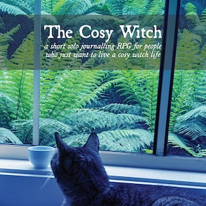 May include: A grey cat gazes out of a window at a verdant scene. The text "The Cosy Witch" is visible, advertising a journaling RPG. A small white cup is on the windowsill. The name "Anna" is written at the bottom.