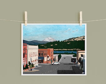 May include: A colorful illustration of a small town with a mountain in the background. The text "small town BIG heart" is written in the sky. The town has a few buildings, a river, and a car driving down the street.