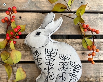 Rabbit soft sculpture hand painted with quirky patterns, perfect decoration for any shelf or desk.