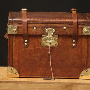 Leather and brass doll&#39;s trunk with key