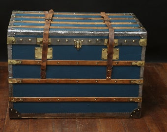 Flat blue steamer trunk with key